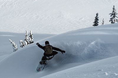 Man skiing on snow covered mountain