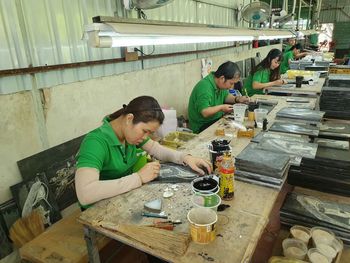 High angle view of people working on table