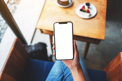 Midsection of woman using mobile phone