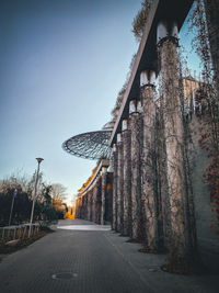 Street amidst trees and buildings against sky