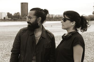 Young couple on land against sky