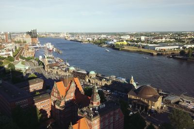 High angle view of cityscape by sea against sky