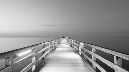 Pier over sea against clear sky