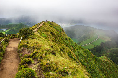 Scenic view of green landscape against sky