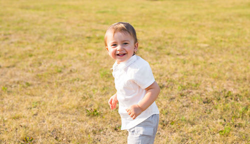 Portrait of happy boy standing on land