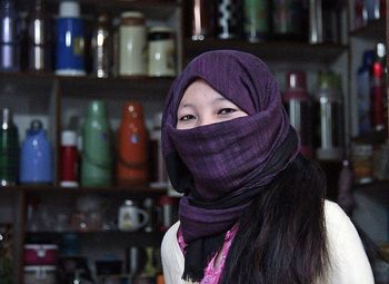 Portrait of young woman wearing mask outdoors at night