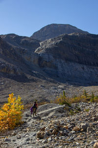 Rear view of man walking on mountain