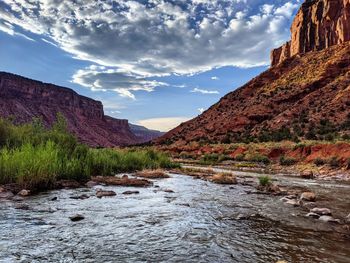 Scenic view of mountains against sky. canyons meet a beautiful river in the american southwest.