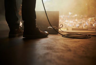 Low section of man standing on table