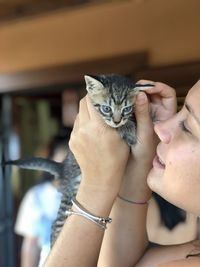 Close-up of woman holding cute kitten