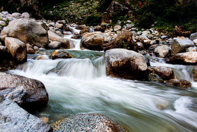 Stream flowing through rocks in forest