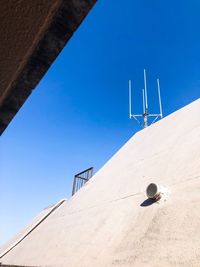 Low angle view of antenna against clear blue sky