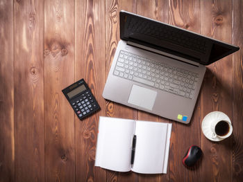 High angle view of laptop and coffee cup on table