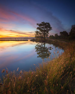 Scenic view of lake against sky during sunset