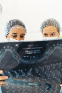 Female dentists examining x-ray at clinic