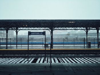 Empty railroad station platform against clear sky