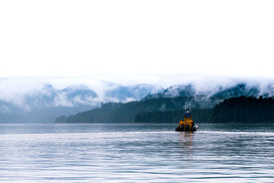 Boat on lake against clear sky