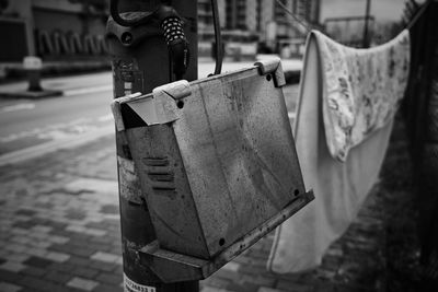 Close-up of old chain hanging on street