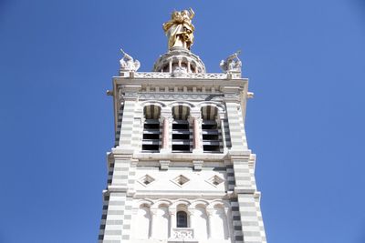 Low angle view of notre-dame de la garde against clear blue sky