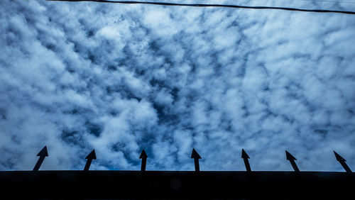 Low angle view of silhouette crane against sky at dusk