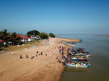 High angle view of people on beach against clear sky