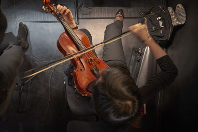 High angle view of man playing violin