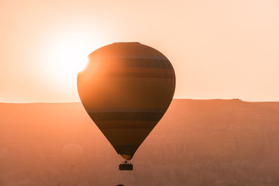 Hot air balloon against clear sky during sunset