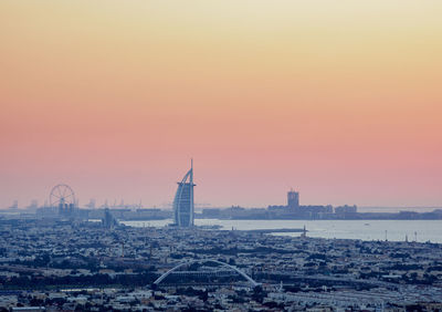 Buildings in city during sunset