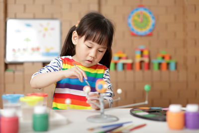Cute girl painting at home