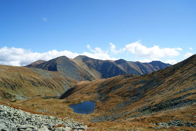 Scenic view of mountains against blue sky