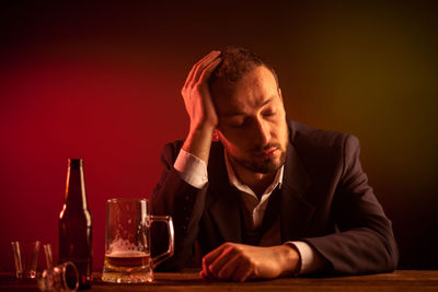 Portrait of young man sitting at table