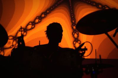 Silhouette of man at music concert