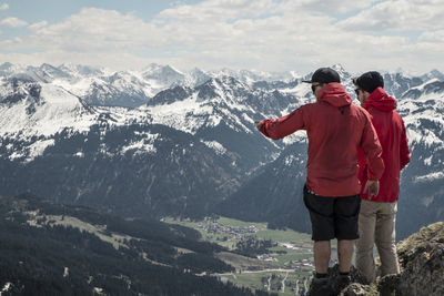 Rear view of men against european alps