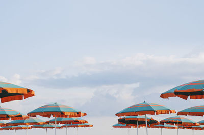 Boats in sea against cloudy sky