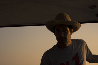 Portrait of man wearing cowboy hat in boat