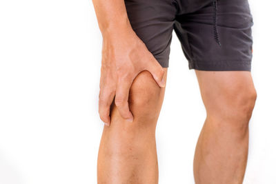 Midsection of man standing against white background