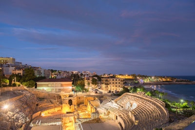 High angle view of buildings in city at night