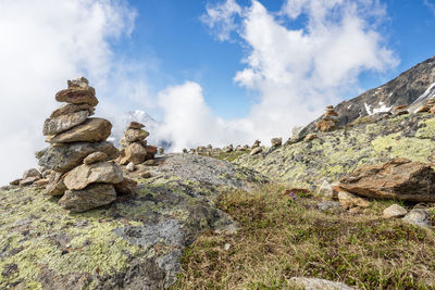 Low angle view of rocks on mountain against sky