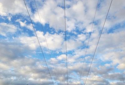 Low angle view of vapor trails against sky