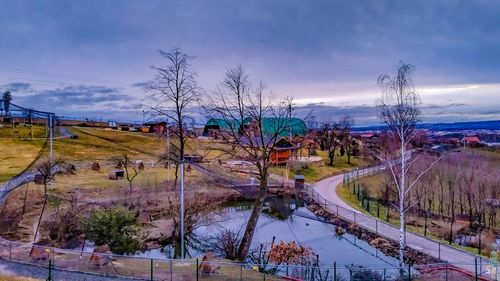 Panoramic shot of trees by plants against sky