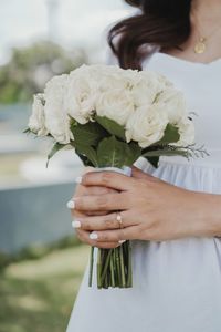 Midsection of woman holding bouquet