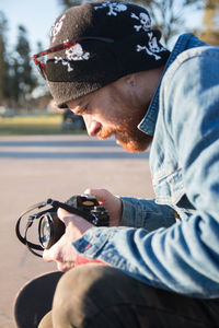 Portrait of young man photographing