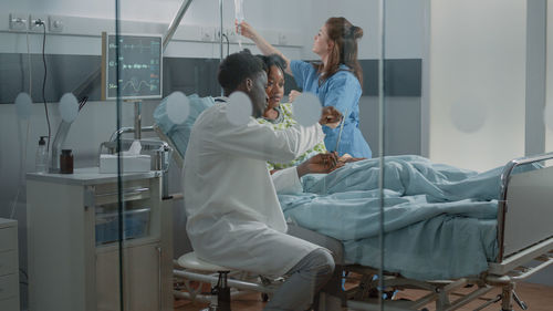 Female doctor examining patient in clinic