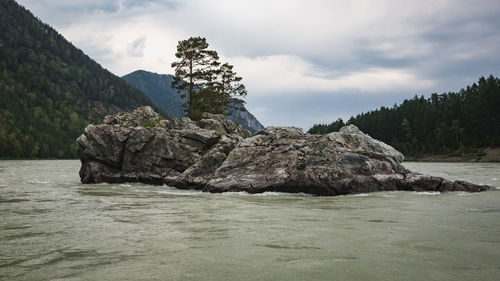 Scenic view of sea and mountains against sky