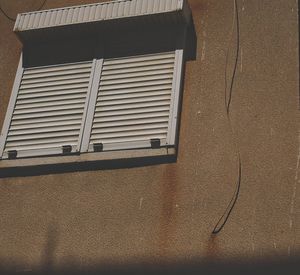 Low angle view of window on wall of building