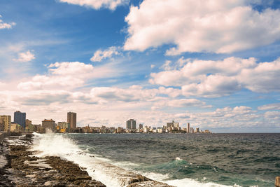 Scenic view of sea and buildings against sky