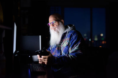 Man using mobile phone while sitting on table