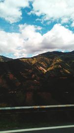 Scenic view of mountains against cloudy sky