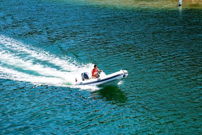 High angle view of man riding on boat in sea