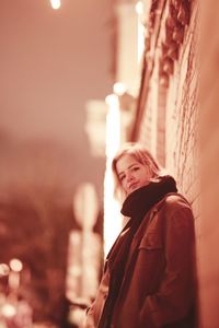 Side view portrait of young woman standing outdoors